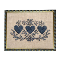 a framed embroidered design with three blue hearts and floral elements.