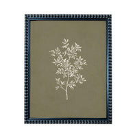 A framed print of a white tree with green leaves, displayed in a dark blue frame with a textured border.