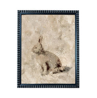 The image is a framed painting of a rabbit sitting on the ground.