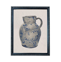 A blue and white ceramic pitcher with a floral pattern on its body.