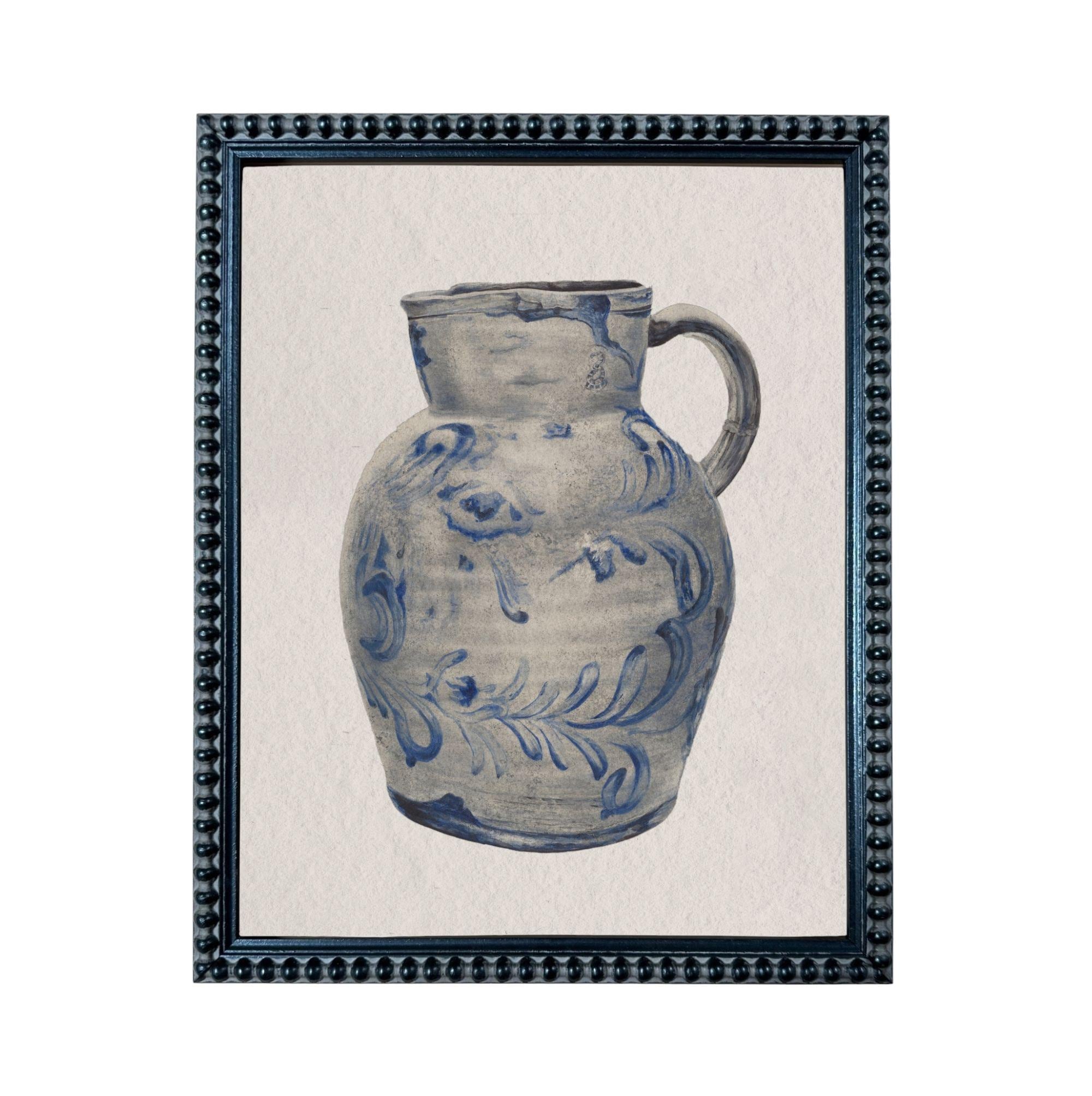 A blue and white ceramic pitcher with a floral pattern on its body.