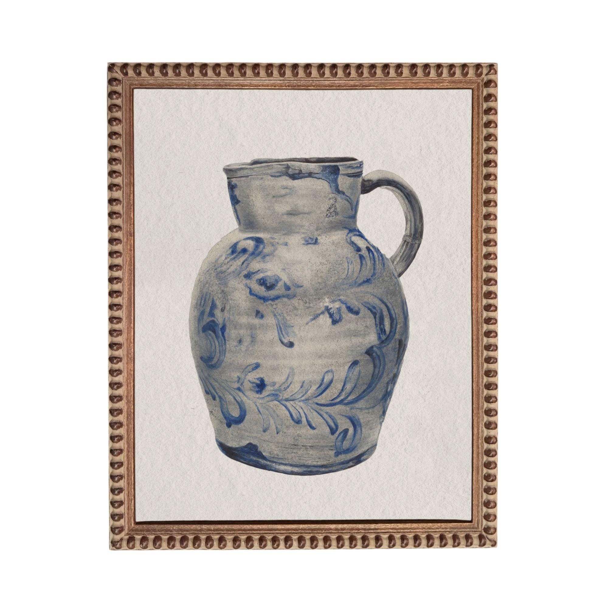 A blue and white ceramic pitcher with a floral pattern on its surface, displayed in a framed artwork.
