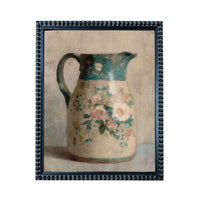 A framed painting depicting a floral-patterned pitcher against a neutral background.