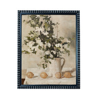 The image is a framed painting depicting a vase of flowers and three lemons on a table.
