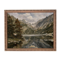 The image is a painting of a serene mountain landscape with a lake in the foreground. The painting features a reflection of the mountains and trees in the lake, creating a sense of depth and tranquility. The painting is framed with a decorative border, adding an elegant touch to the overall composition.