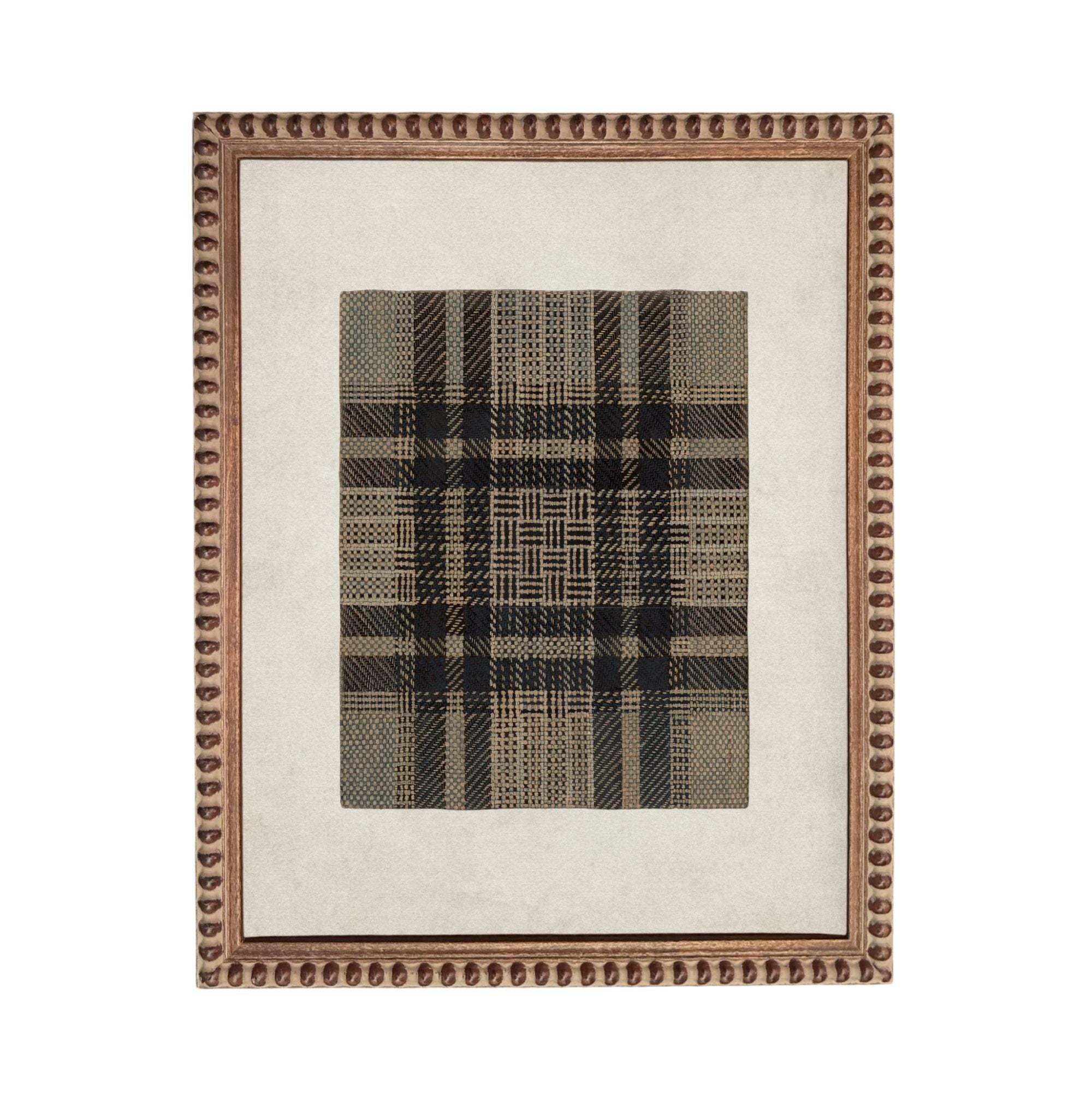 a square-shaped frame with a decorative border, containing a black and white checkered pattern.