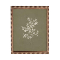 a framed artwork depicting a tree with white leaves against a green background.