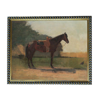 a brown horse standing in a field, with a person riding on its back.