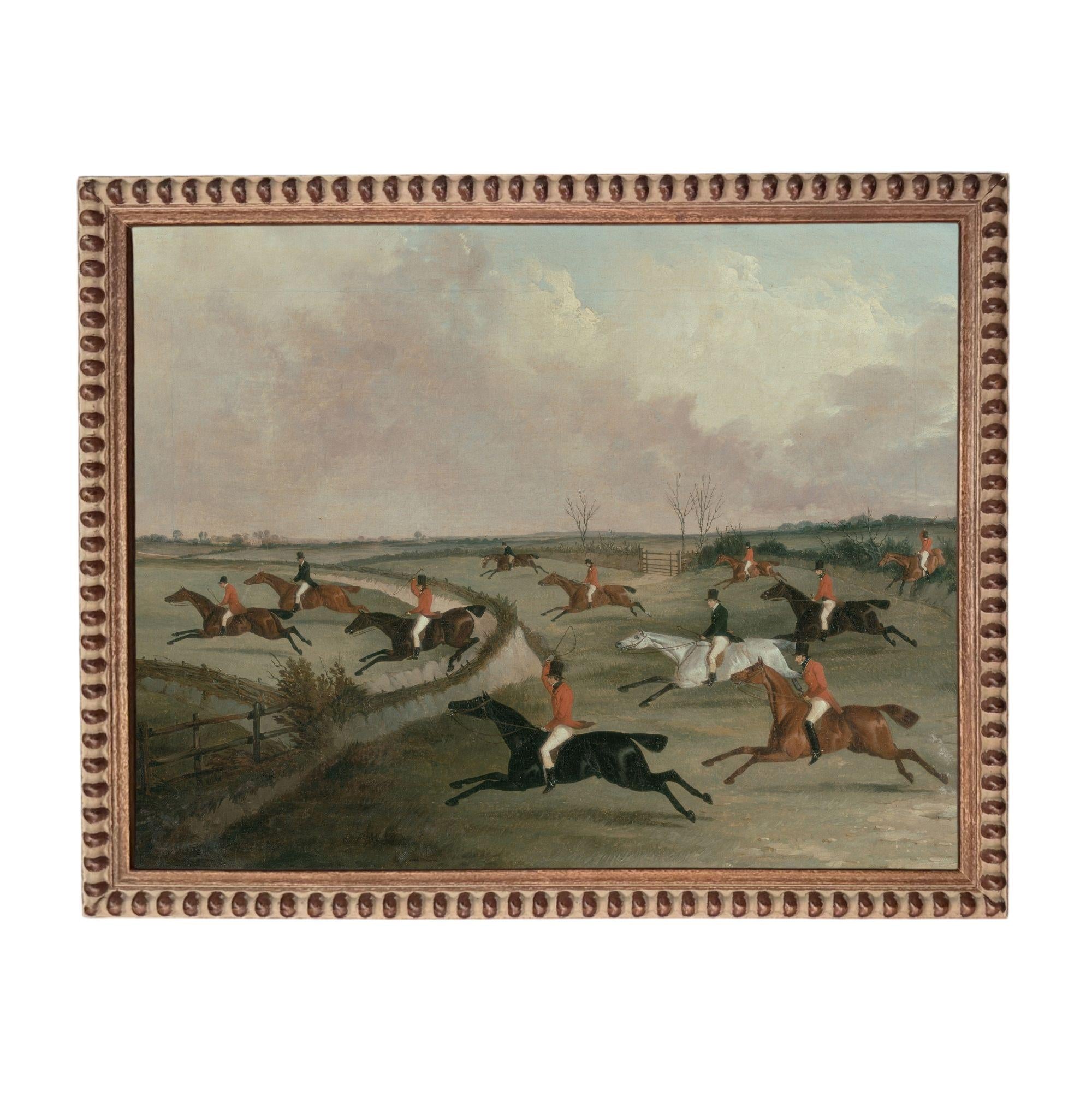 a group of people riding horses in a field, with some horses galloping and others running.