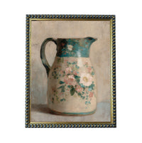 A framed painting depicting a floral-patterned pitcher.